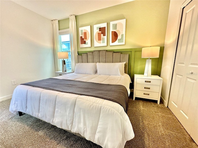 bedroom featuring a closet and dark colored carpet