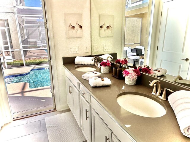 9095 Sommerset Hills Dr, Davenport, FL 33896 - bathroom featuring double vanity, tile patterned flooring, and a sink