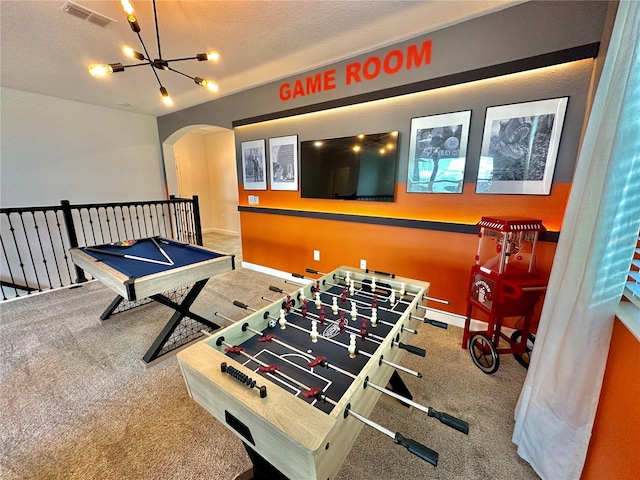 9095 Sommerset Hills Dr, Davenport, FL 33896 - recreation room featuring carpet flooring, an inviting chandelier, baseboards, arched walkways, and visible vents