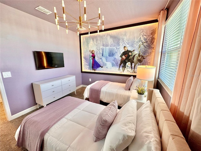 carpeted bedroom with a textured ceiling and a notable chandelier