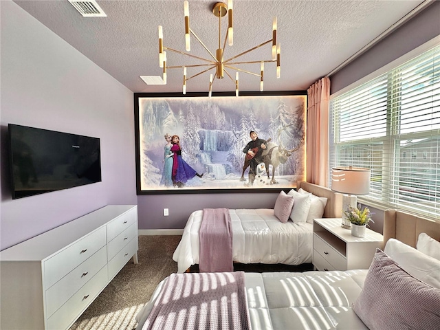 bedroom featuring dark colored carpet, an inviting chandelier, and a textured ceiling