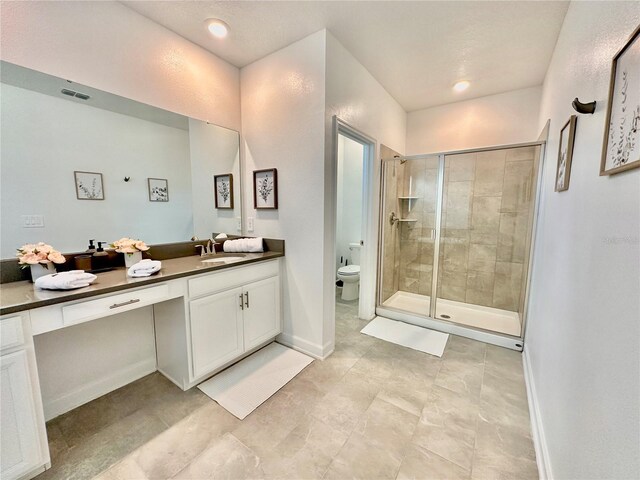 9095 Sommerset Hills Dr, Davenport, FL 33896 - bathroom with toilet, vanity, a shower stall, baseboards, and visible vents