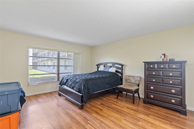 bedroom featuring a textured ceiling and hardwood / wood-style floors