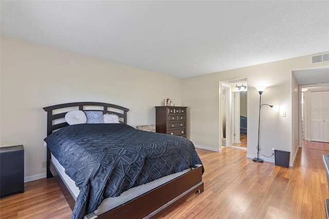 bedroom featuring a textured ceiling and hardwood / wood-style floors