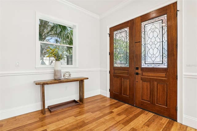 foyer entrance featuring light hardwood / wood-style floors and ornamental molding