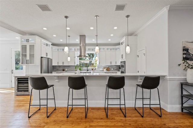 kitchen with wine cooler, stainless steel fridge, light hardwood / wood-style floors, and white cabinetry