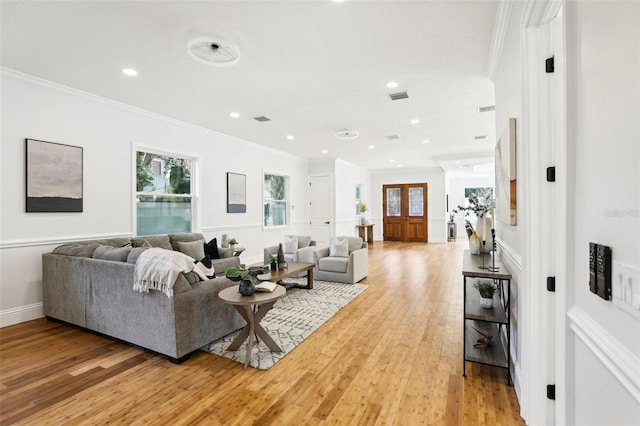 living room featuring light wood-type flooring and ornamental molding