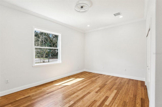 unfurnished room with crown molding and hardwood / wood-style floors