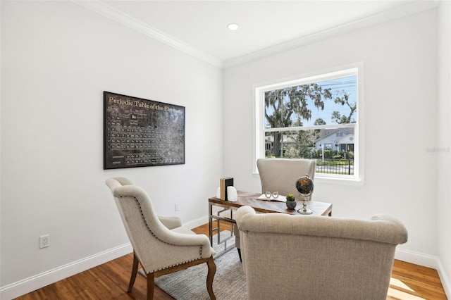 sitting room with ornamental molding and hardwood / wood-style flooring