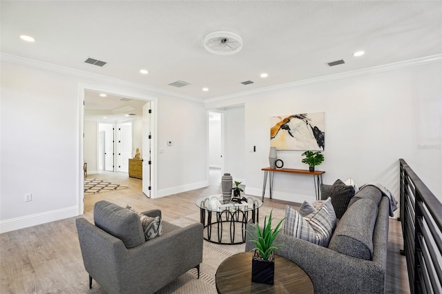 living room with ornamental molding and light hardwood / wood-style flooring