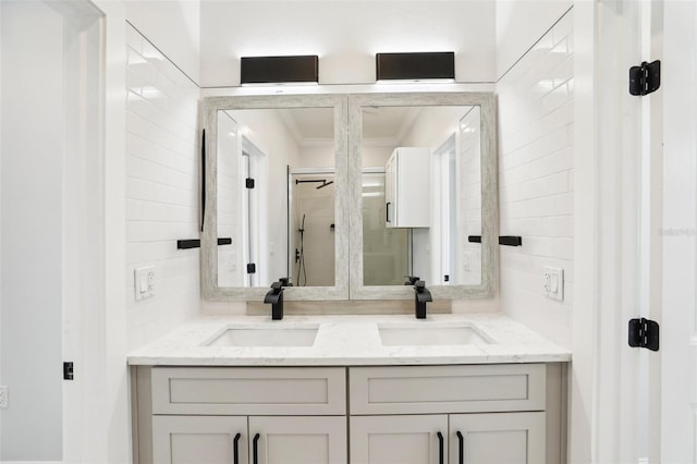 bathroom featuring walk in shower, vanity, and ornamental molding