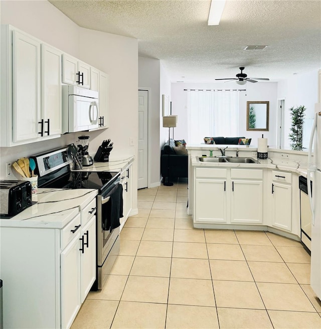 kitchen featuring ceiling fan, sink, white appliances, and white cabinets