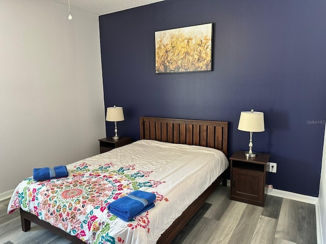1138 Knollwood Dr, Davenport, FL 33837 - bedroom with baseboards and wood finished floors