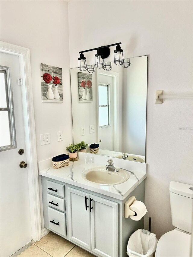 bathroom with tile patterned flooring, vanity, and toilet