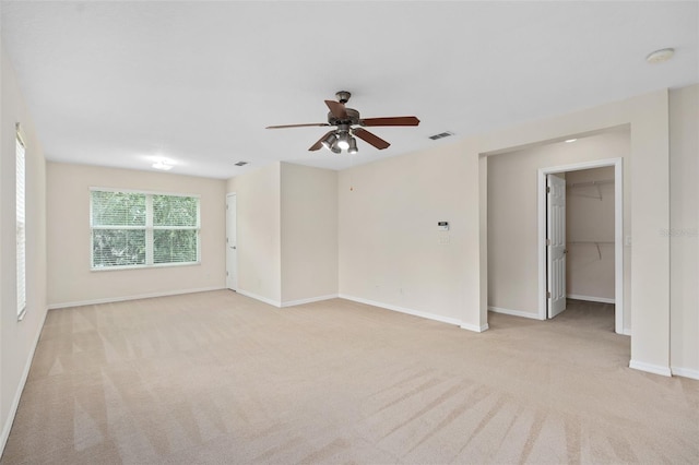 carpeted empty room with ceiling fan