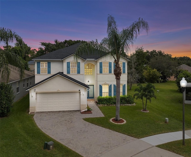 view of front of house with a lawn and a garage