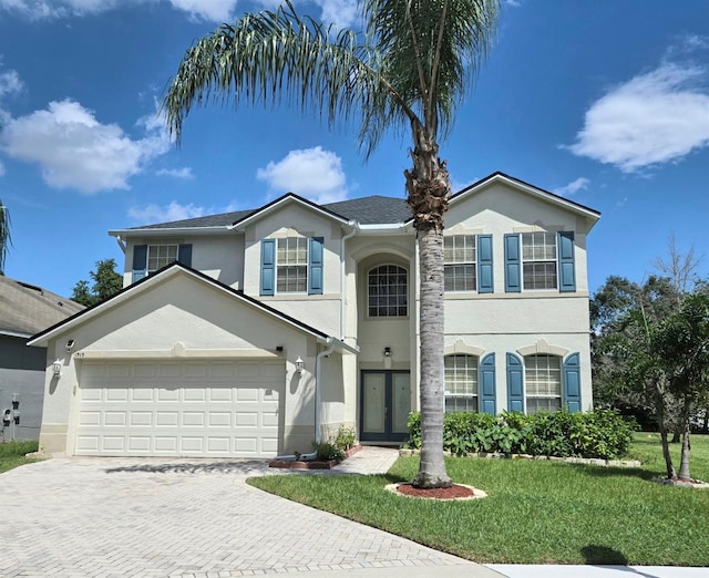 view of front property with a front yard and a garage