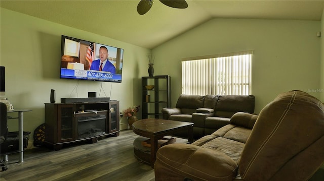 living room featuring ceiling fan, wood-type flooring, and vaulted ceiling