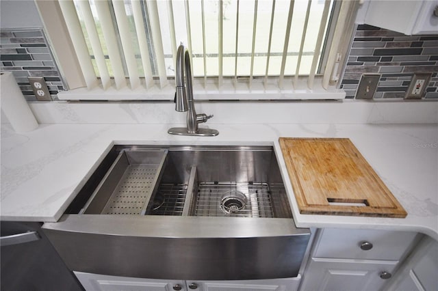 details featuring decorative backsplash and white cabinets