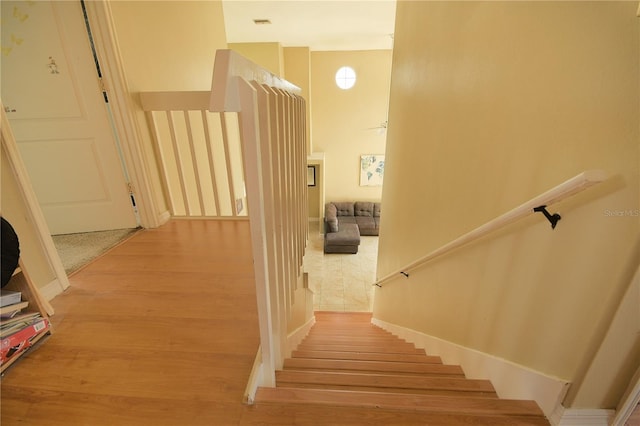 staircase with hardwood / wood-style floors