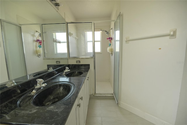 bathroom with vanity and a shower with door