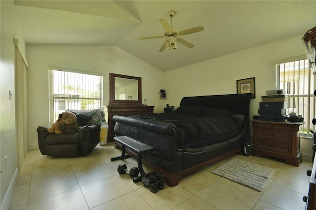 bedroom with ceiling fan, light tile patterned floors, and vaulted ceiling