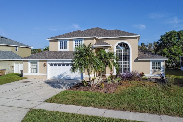 view of front of property with a front yard and a garage