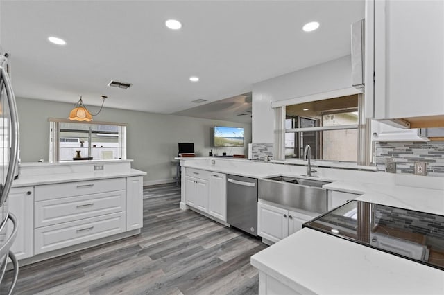 kitchen featuring white cabinets, dishwasher, tasteful backsplash, and sink