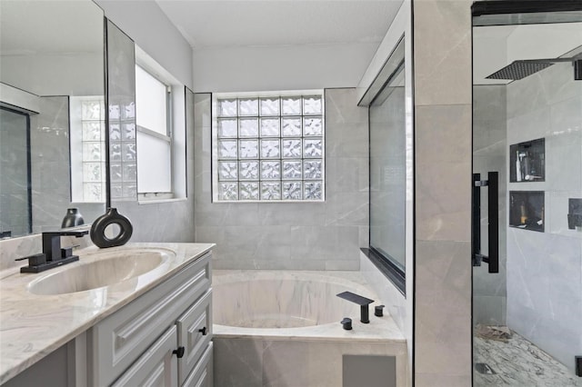 bathroom featuring separate shower and tub and vanity