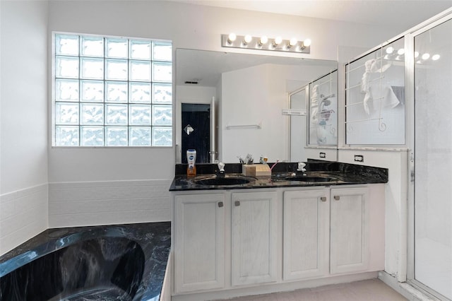 bathroom with separate shower and tub and vanity