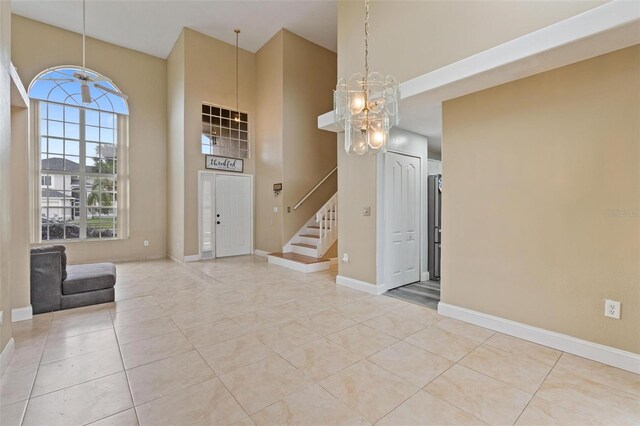 entryway featuring a high ceiling and light tile patterned floors