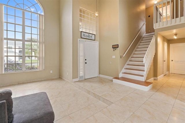 tiled foyer entrance with a high ceiling