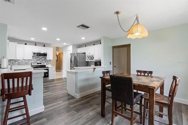 dining area with dark hardwood / wood-style flooring and sink