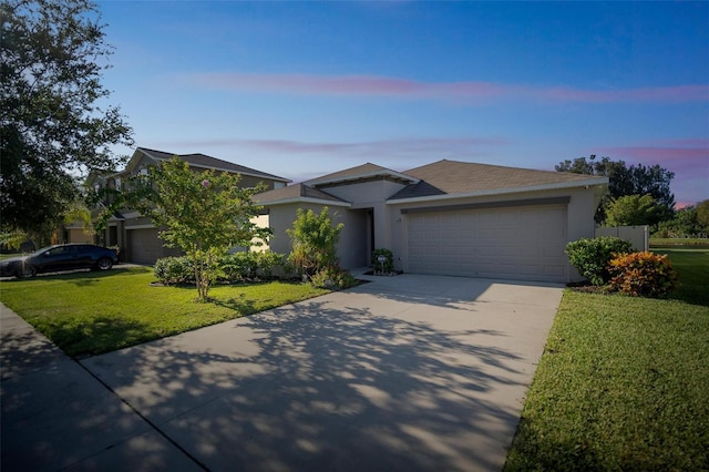 view of front of home featuring a lawn and a garage