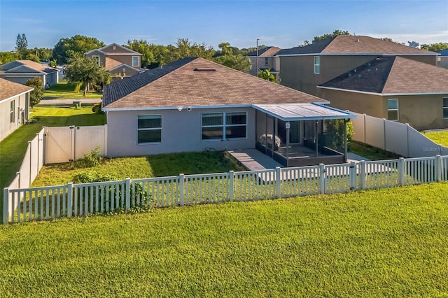 back of house with a lawn