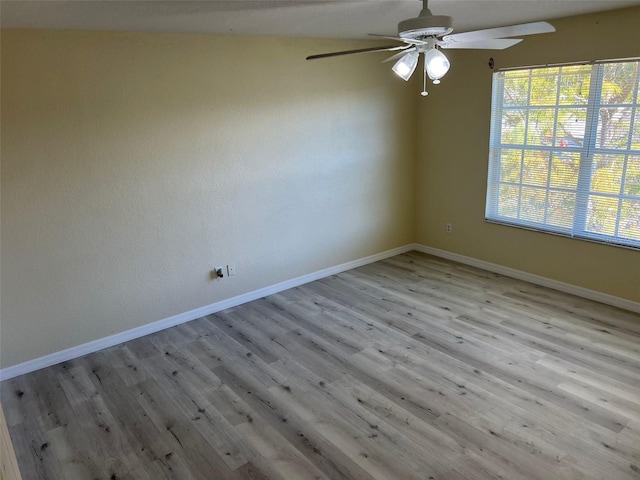 empty room with a healthy amount of sunlight, light hardwood / wood-style flooring, and ceiling fan