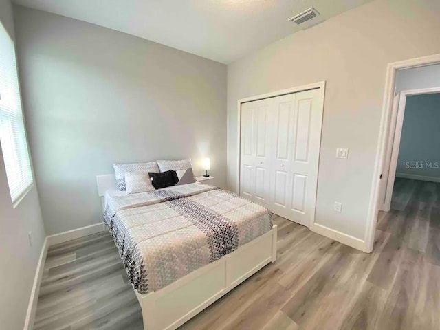 bedroom with a closet and hardwood / wood-style floors