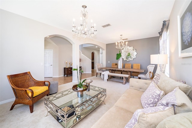 living room with light carpet and a chandelier