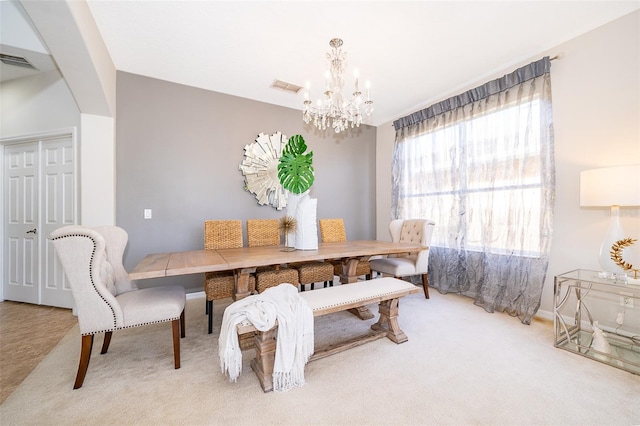 carpeted dining area with a notable chandelier