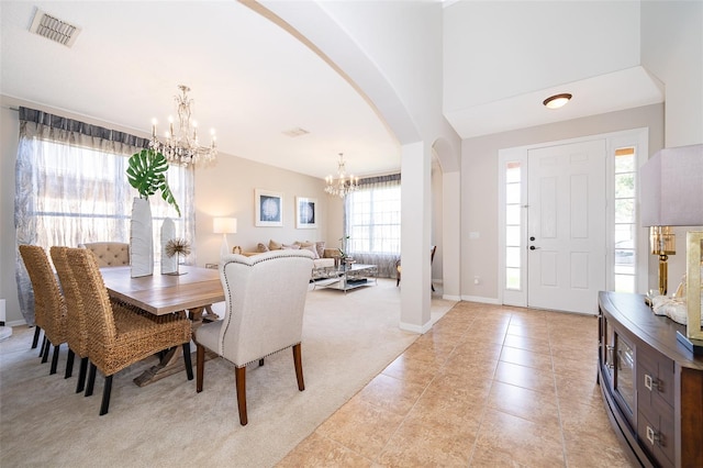 tiled dining space with an inviting chandelier