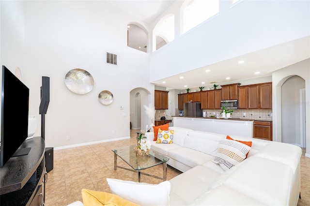 tiled living room with a high ceiling