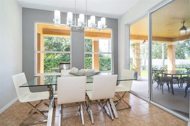 tiled dining area featuring ceiling fan with notable chandelier