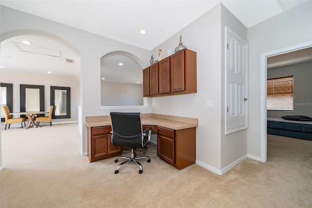 carpeted home office with built in desk