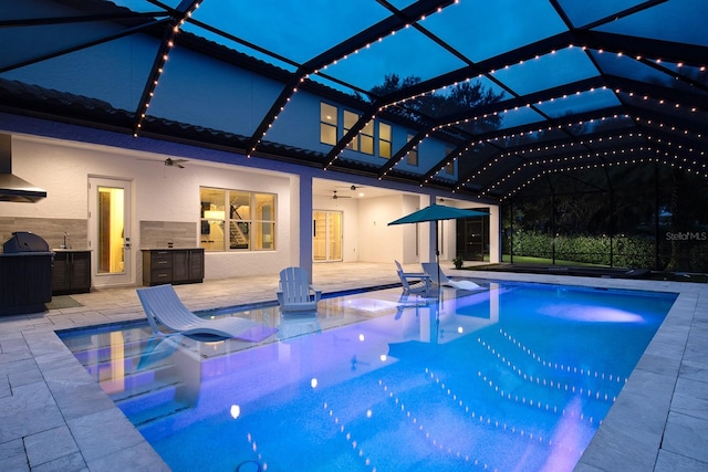 view of pool featuring a lanai, a patio, and ceiling fan