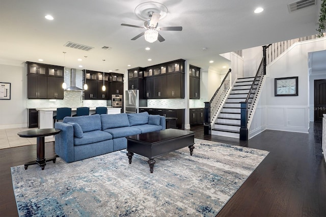 living room with dark wood-type flooring and ceiling fan