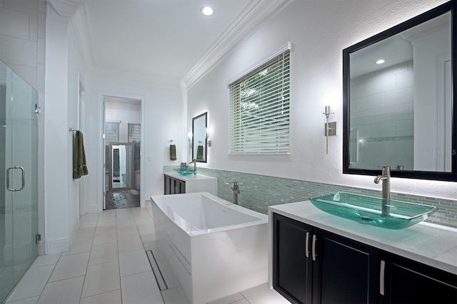 bathroom with vanity, shower with separate bathtub, tile walls, crown molding, and tile patterned flooring