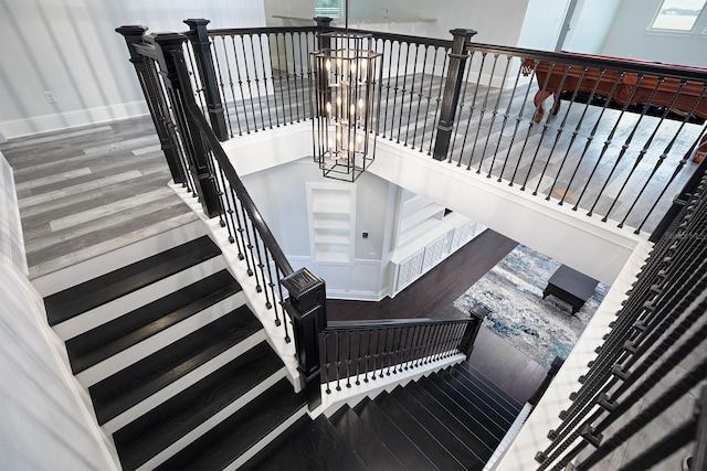 staircase with a notable chandelier