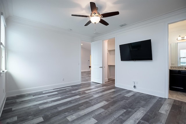 interior space featuring ceiling fan, dark wood-type flooring, and crown molding