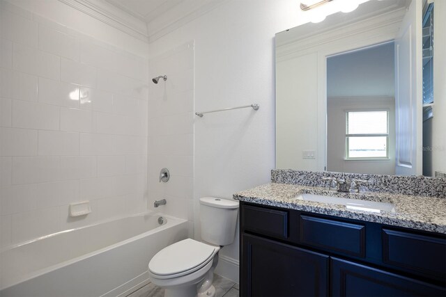 full bathroom with tiled shower / bath, vanity, crown molding, and toilet