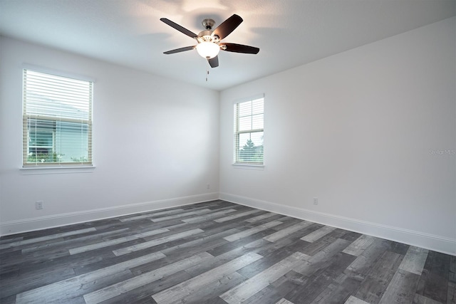 empty room featuring ceiling fan and dark hardwood / wood-style floors